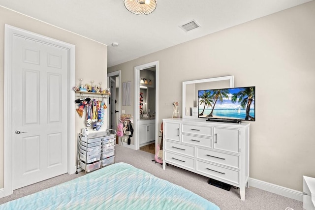 carpeted bedroom featuring ensuite bathroom