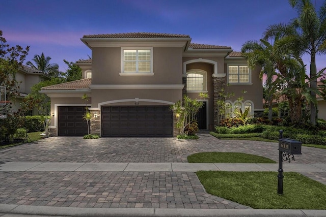 mediterranean / spanish home featuring a garage