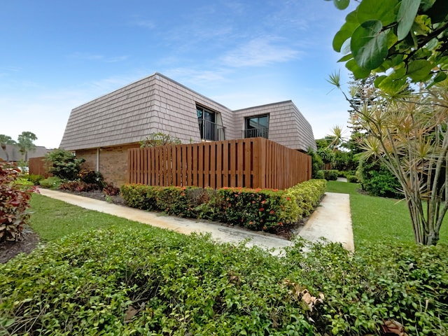 view of side of home featuring a lawn