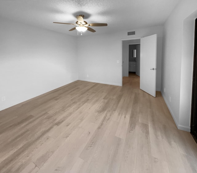 spare room featuring ceiling fan, a textured ceiling, and light hardwood / wood-style floors