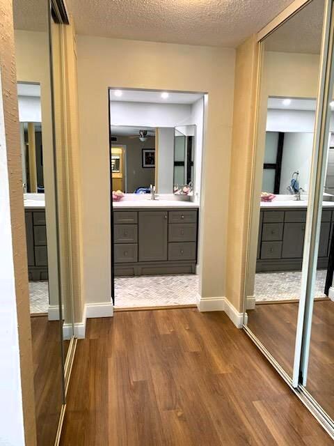 bathroom with vanity, hardwood / wood-style floors, and a textured ceiling