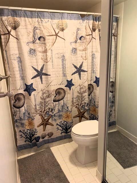 bathroom with toilet and tile patterned flooring