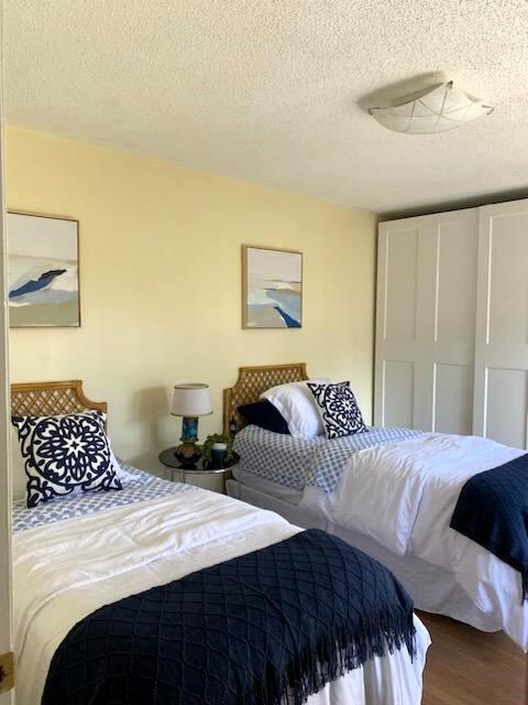 bedroom featuring hardwood / wood-style flooring and a textured ceiling