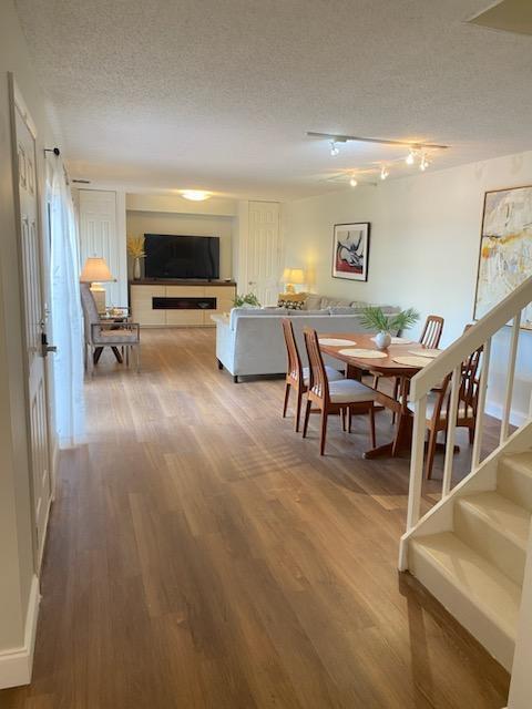 dining space featuring hardwood / wood-style flooring and a textured ceiling