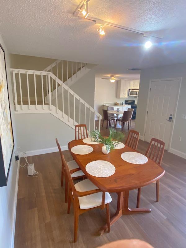 dining area featuring hardwood / wood-style flooring and a textured ceiling