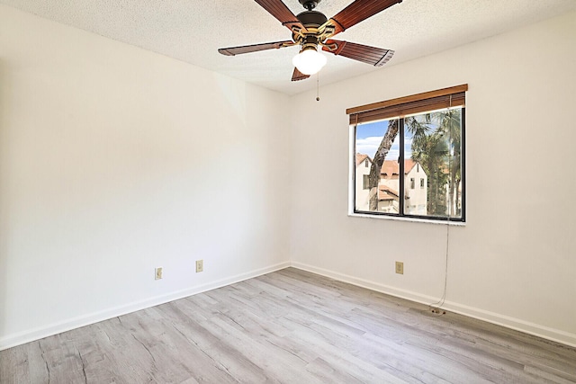 empty room featuring ceiling fan, a textured ceiling, and light wood-type flooring