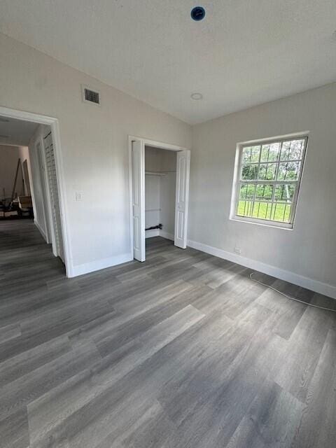 unfurnished bedroom with a closet and wood-type flooring