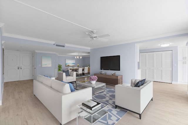 living room featuring light hardwood / wood-style flooring, crown molding, and ceiling fan with notable chandelier