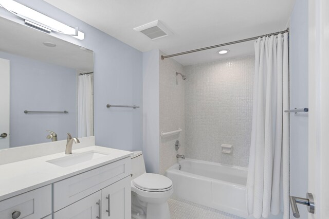 full bathroom featuring shower / bath combo, tile patterned floors, vanity, and toilet