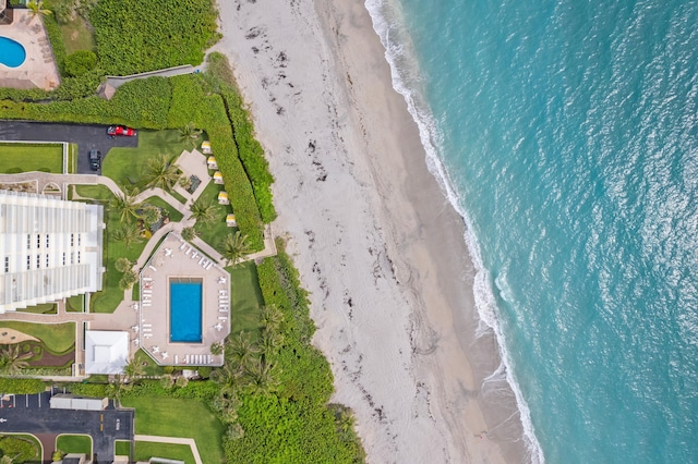 bird's eye view with a water view and a beach view