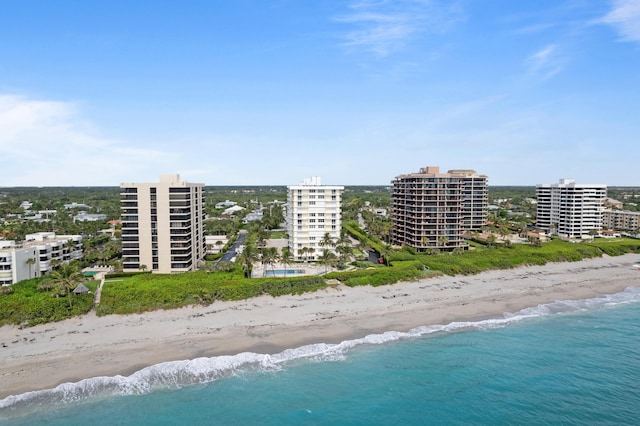 drone / aerial view featuring a water view and a beach view