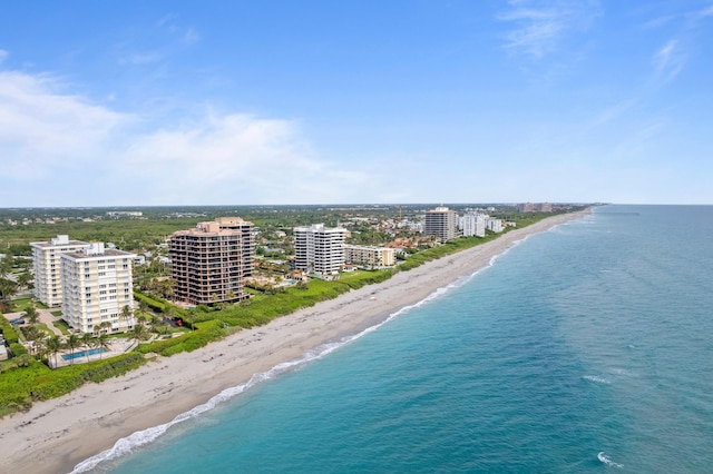 drone / aerial view featuring a water view and a view of the beach