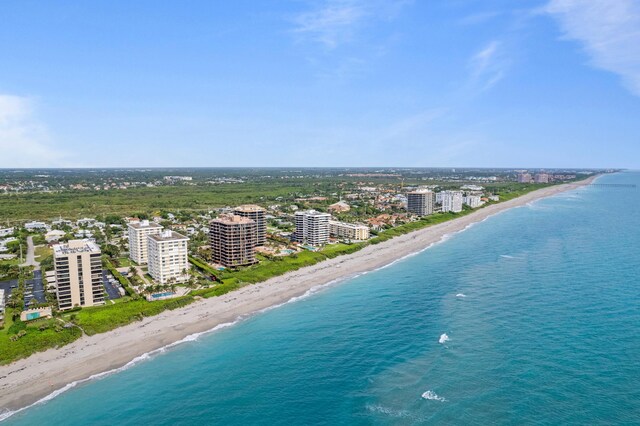 bird's eye view with a water view and a beach view