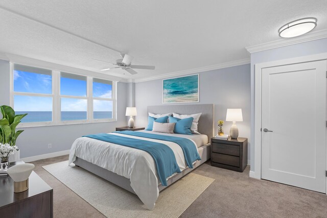 carpeted bedroom with ceiling fan, crown molding, a water view, and a textured ceiling