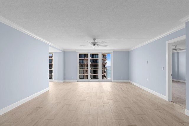 unfurnished room featuring ceiling fan, crown molding, and a textured ceiling