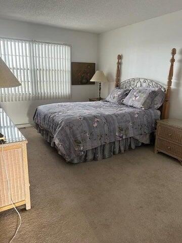 carpeted bedroom with a textured ceiling