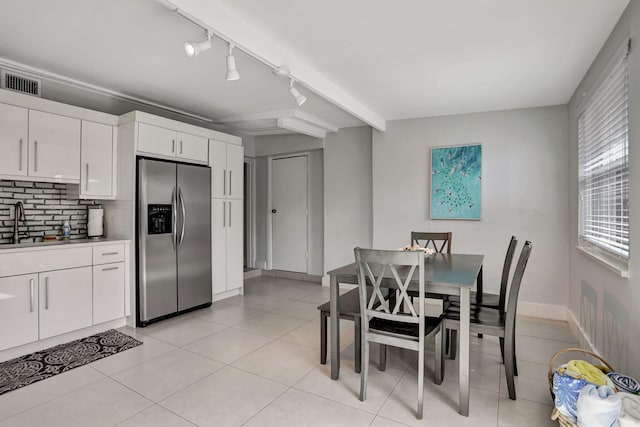 5278 NE 19th Ter, Pompano Beach, FL 33064 - dining space with rail lighting, light tile patterned floors, beamed ceiling, and baseboards
