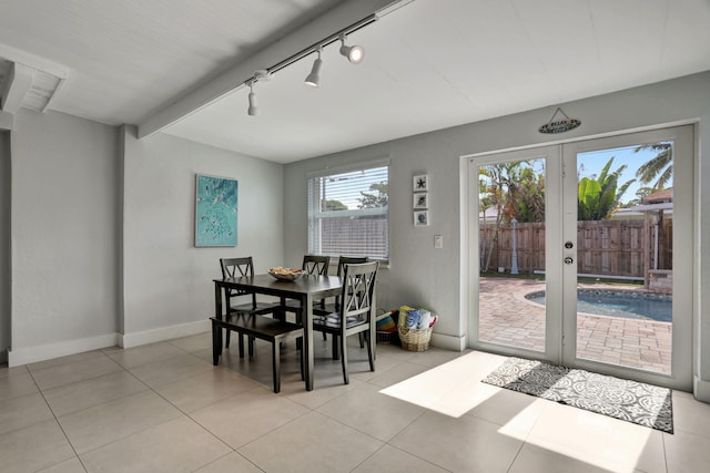 dining space featuring light tile patterned flooring, french doors, and track lighting