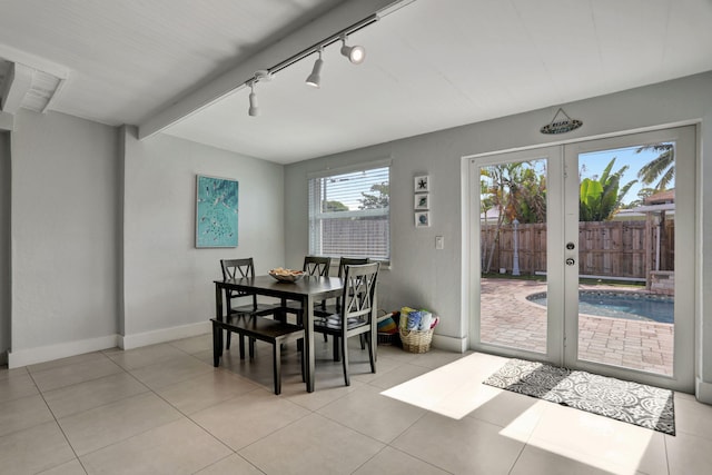 5278 NE 19th Ter, Pompano Beach, FL 33064 - dining space featuring baseboards, track lighting, and light tile patterned floors