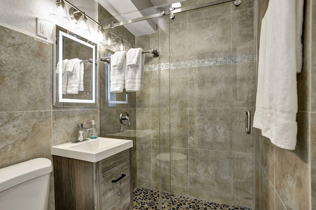 5278 NE 19th Ter, Pompano Beach, FL 33064 - full bathroom with toilet, vanity, a stall shower, and tile walls