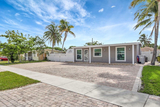 5278 NE 19th Ter, Pompano Beach, FL 33064 - ranch-style house with stucco siding and a gate