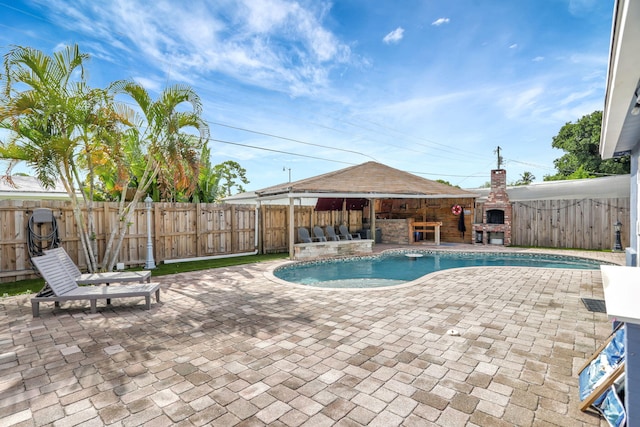 5278 NE 19th Ter, Pompano Beach, FL 33064 - view of swimming pool with a patio, a fenced backyard, and a fireplace