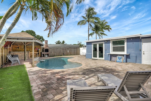 view of swimming pool featuring french doors and a patio area