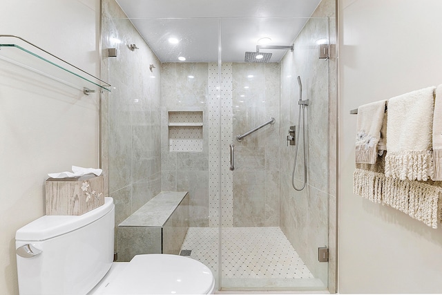 bathroom featuring walk in shower and toilet