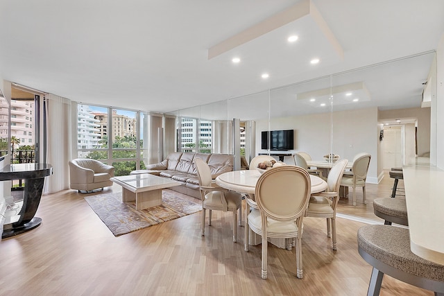 living room featuring expansive windows and light wood-type flooring