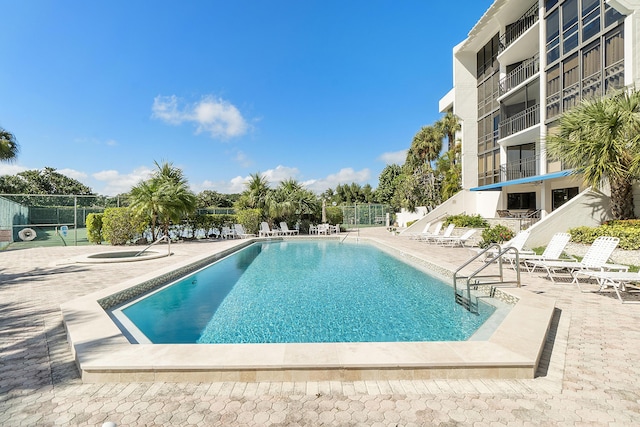 community pool featuring a patio area and fence