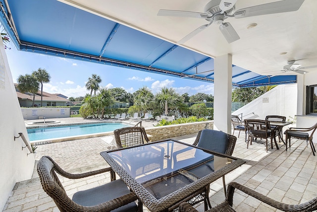 view of patio / terrace featuring ceiling fan, outdoor dining area, and a community pool