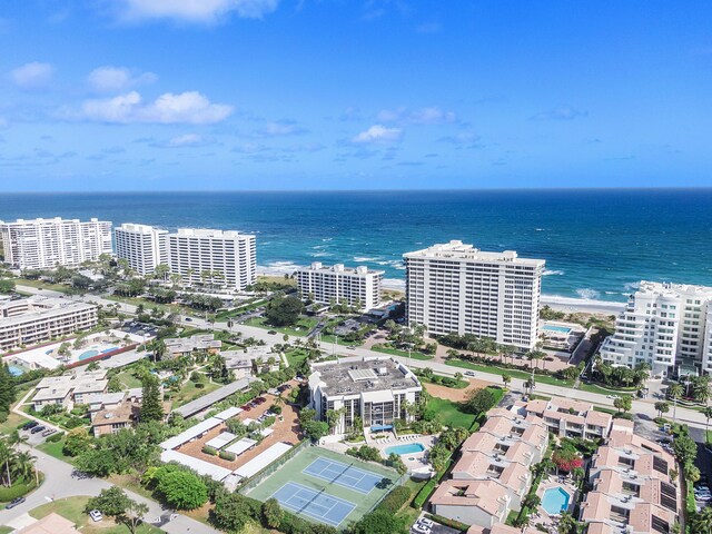 drone / aerial view with a beach view, a water view, and a city view