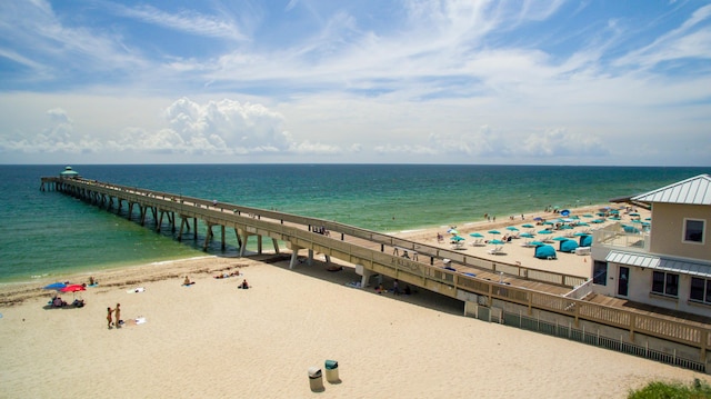 property view of water with a pier and a beach view