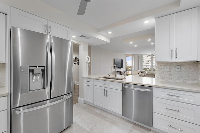 kitchen with white cabinetry, appliances with stainless steel finishes, light countertops, and a sink