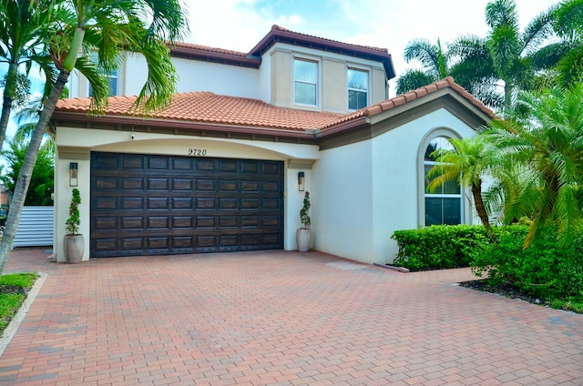 mediterranean / spanish home with a garage