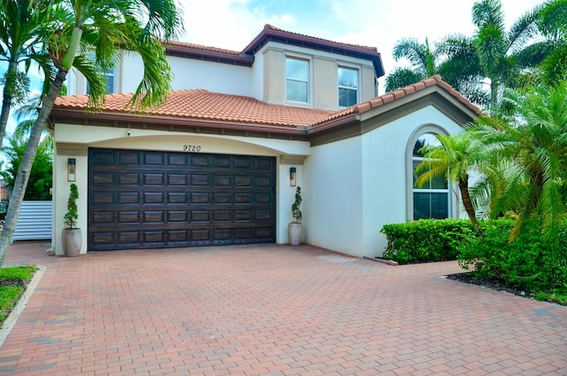 mediterranean / spanish-style house with a garage