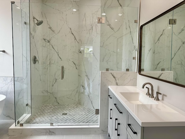 bathroom featuring vanity and a shower with door