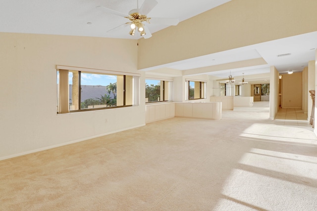 unfurnished living room with light carpet, ceiling fan, and lofted ceiling