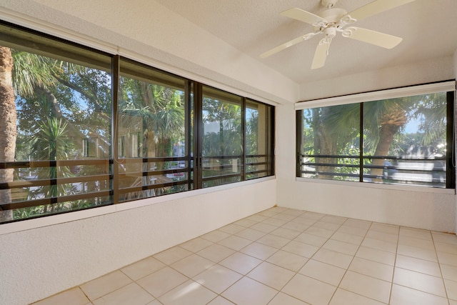 unfurnished sunroom with ceiling fan