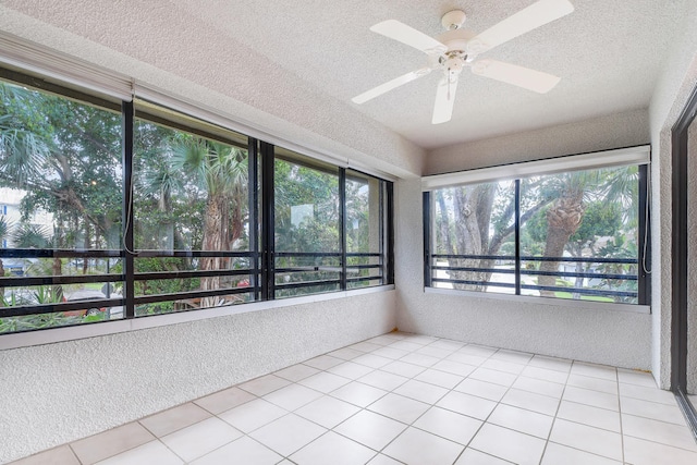 unfurnished sunroom with ceiling fan