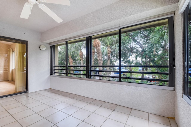 interior space featuring ceiling fan and plenty of natural light