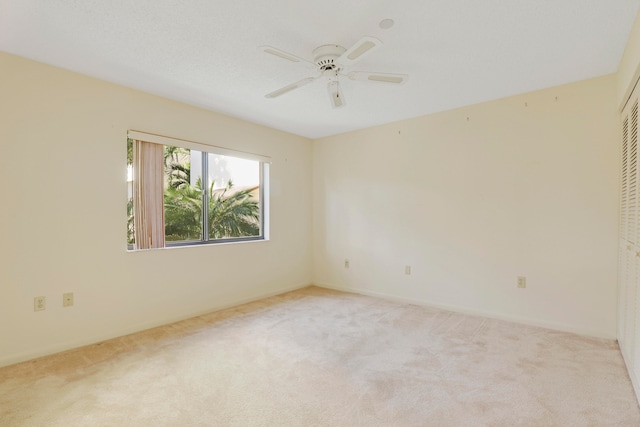 carpeted empty room with ceiling fan