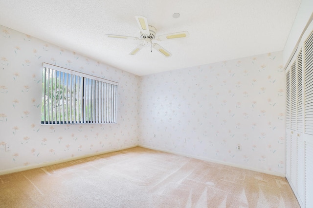 unfurnished bedroom featuring ceiling fan, carpet flooring, and a closet