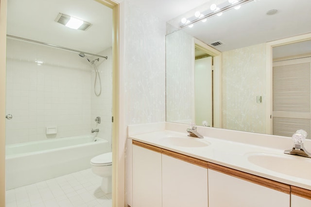 full bathroom featuring dual vanity, toilet, tile patterned floors, and shower / bathing tub combination