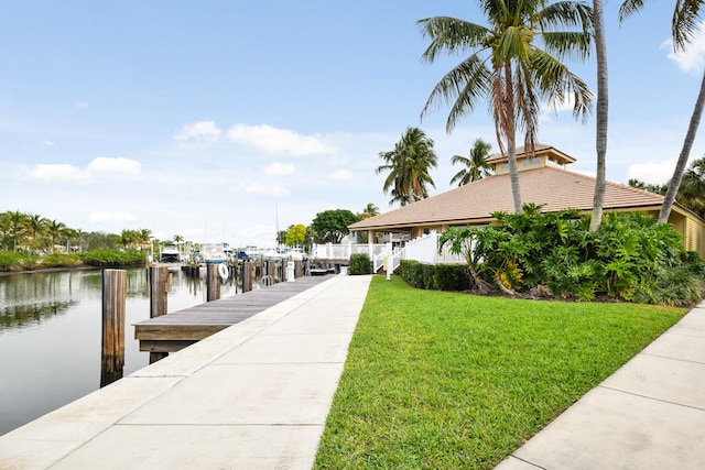 dock area featuring a water view and a yard