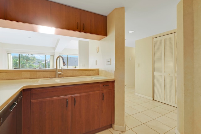 kitchen with sink, stainless steel dishwasher, and light tile patterned floors