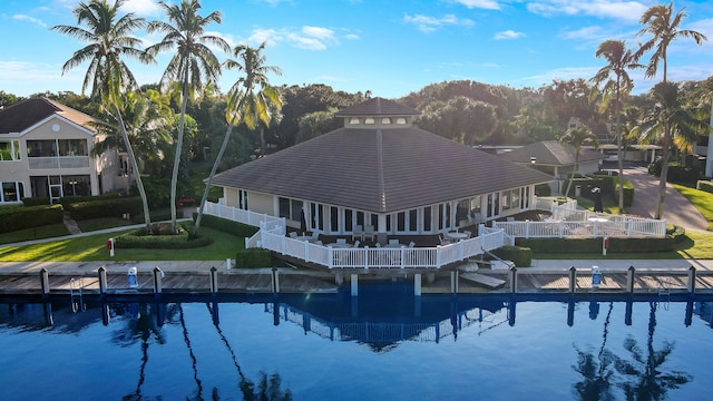 view of swimming pool with a water view, a lawn, and a gazebo