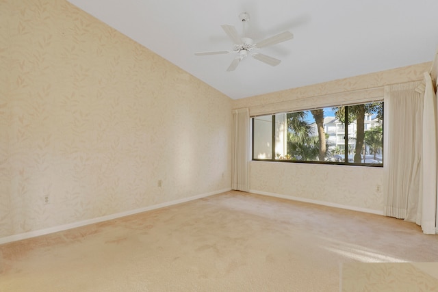 empty room with carpet floors, ceiling fan, and vaulted ceiling