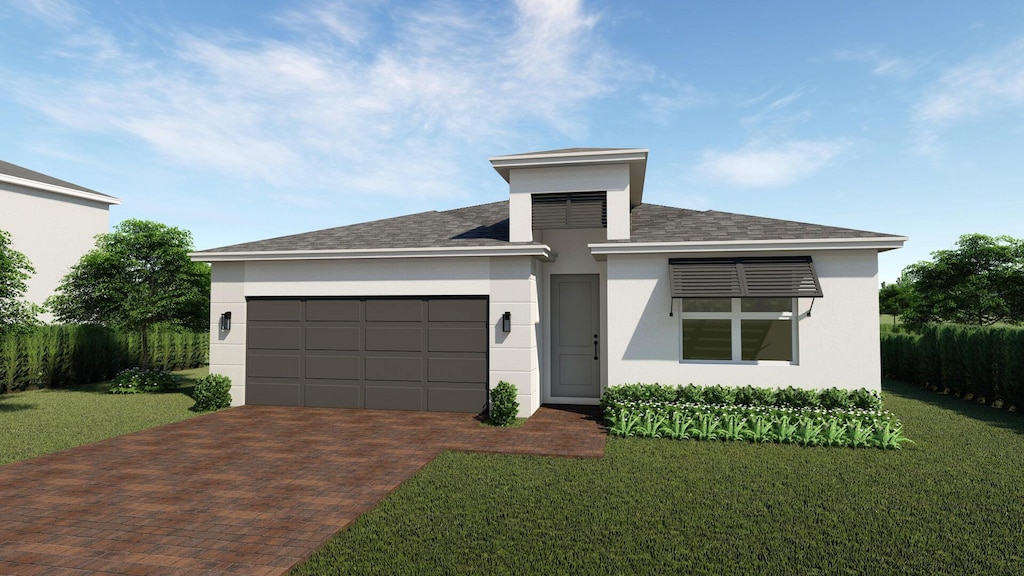 view of front of home with a garage and a front yard