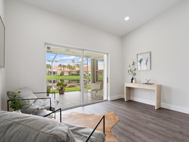 living room with lofted ceiling, wood-type flooring, and a wealth of natural light